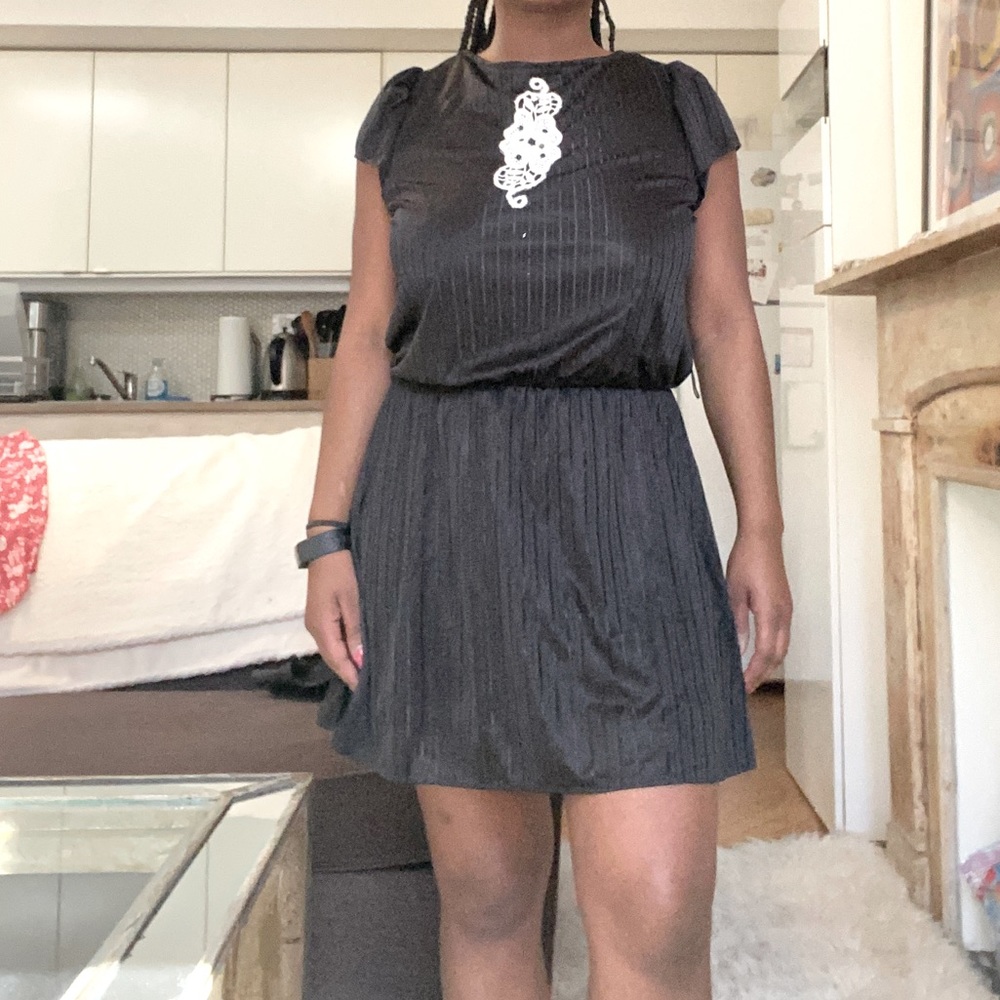 Vintage dress with embroidered emblem on front